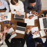 Business people meeting in office, top view